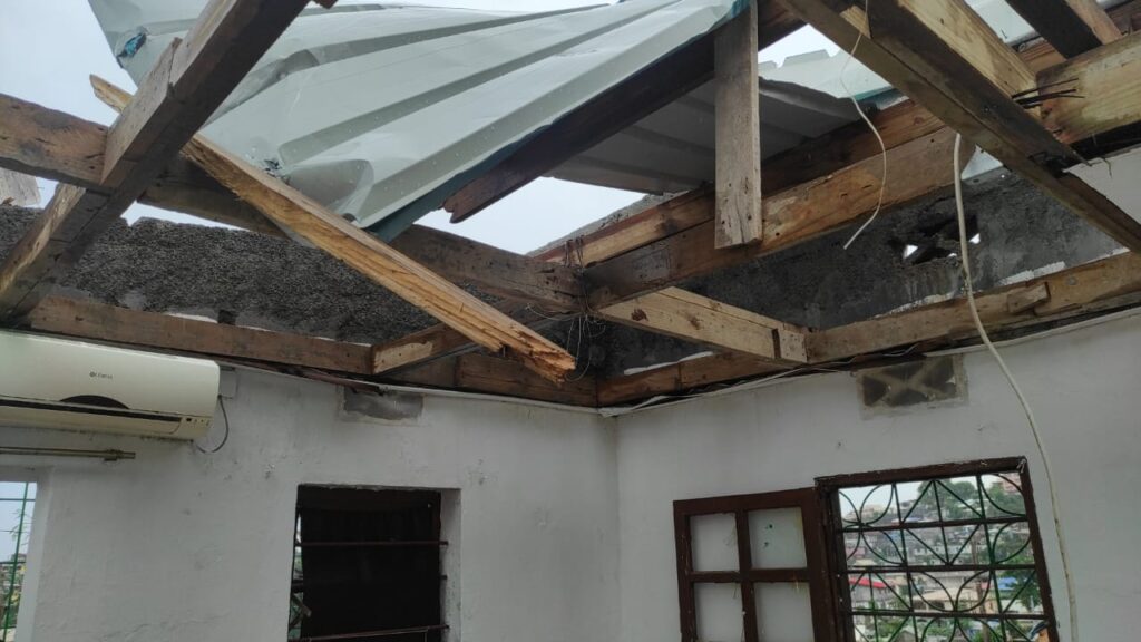 Charpente en bois et couverture cassée après le passage du cyclone Chido à Mayotte en 2025, avec dommages visibles.